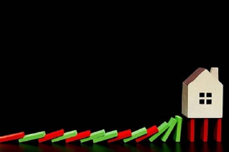 Image shows the domino effect with red and green bars with a house at the end standing on red bars