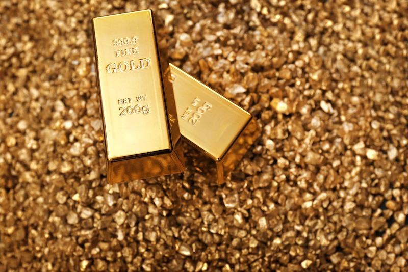 Gold bar placed on golden glitter