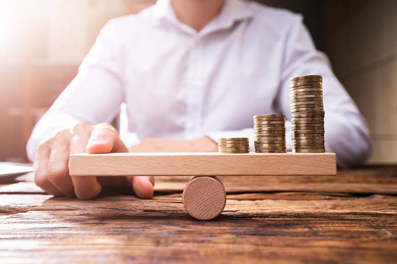 balancing coins on wood