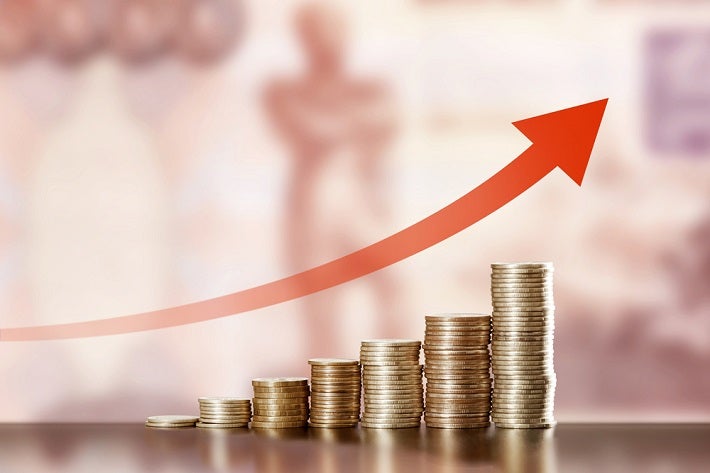 Image: Upward arrow with pile of coins