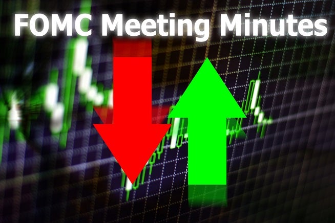 FOMC - Federal Open Market Committee Meeting minutes written on an image of red down arrow and green up arrow