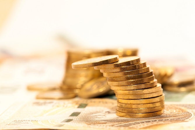 Gold coins sitting on US paper money