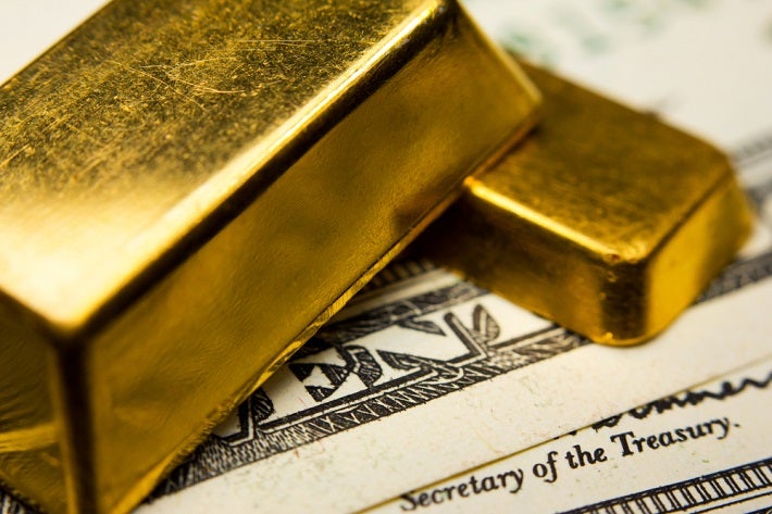 On the paper money is small gold bar and on top of that is biggere gold bar