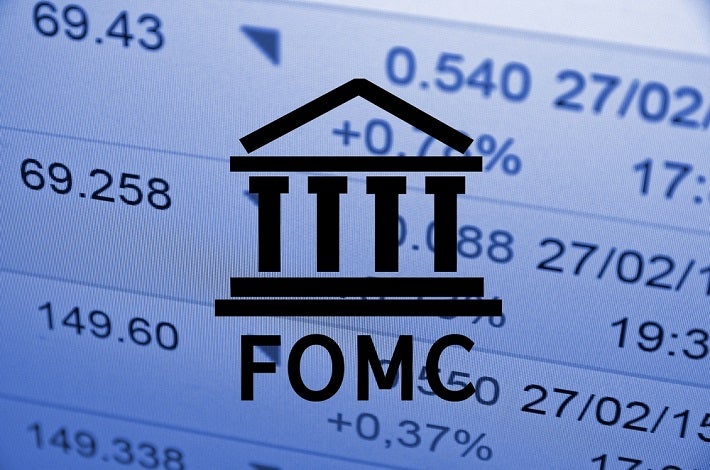 FOMC - Federal Open Market Committee logo with some statistics in the background