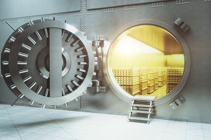 Image of open vault showing stacks of gold bars inside