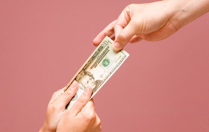 Image showing one hand giving away the dollar bill and other two hands taking that bill