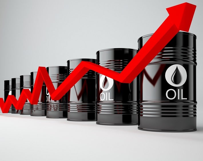 Image of oil barrels lined up with a arrow moving up and down to show variable price.
