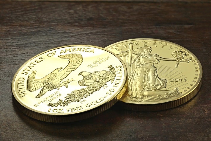 Two gold bullion showing different figures on them