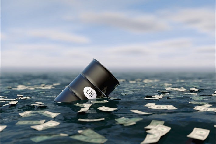 A barrell of oil floating in a sea of water and floating paper money.