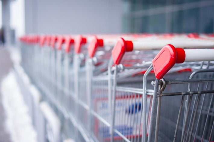 Close up view of a row of shopping carts that continues off into the horizon