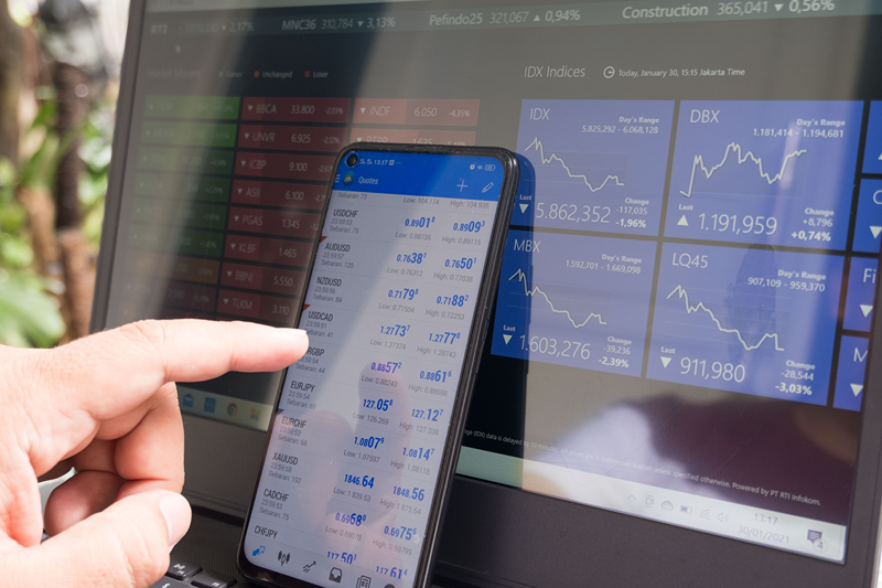stock charts on iphone and laptop