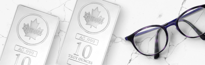 Two silver bars next to a pair of glasses