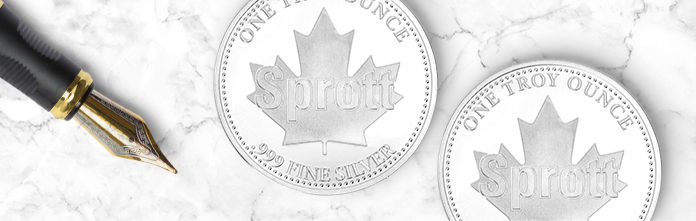 Two silver coins next to a pen